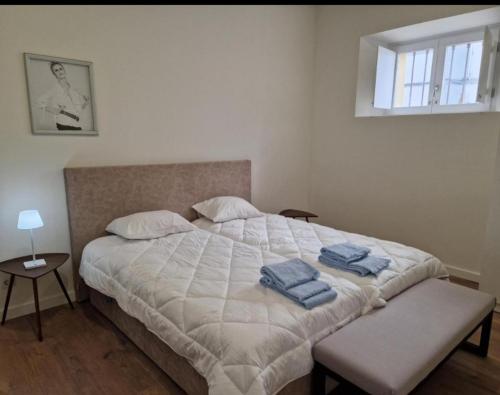 a bedroom with a bed with two towels on it at Casa do Leão II in Évora