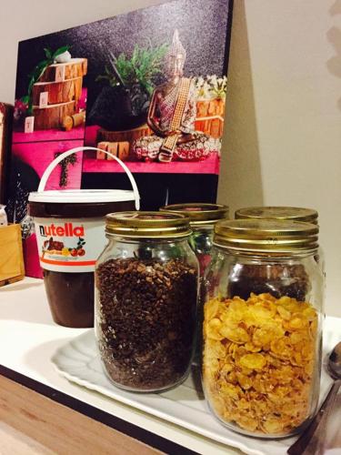 three jars of food sitting on a shelf at Hotel Piero Della Francesca in Arezzo