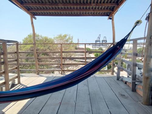 a hammock on a deck with a view of the beach at mirador 1 in Santa Marta