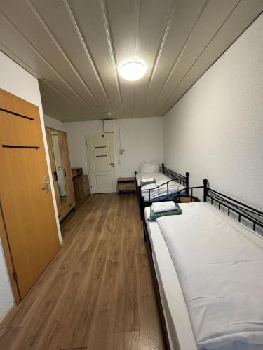 a room with two beds and a hallway at Era Singles in Murg