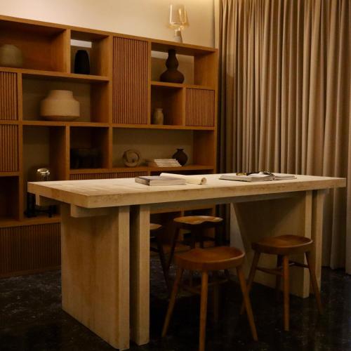 a large wooden table with stools in a room at Hotel Boutique Sina in Guadalajara