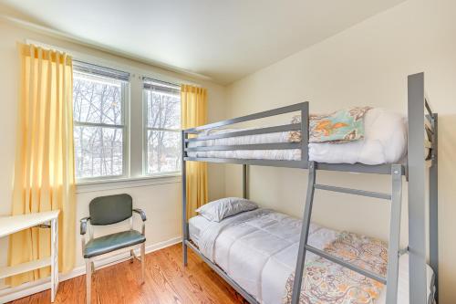 a bedroom with two bunk beds and a chair at Bright Home Near Pine Lake with Deck and Yard in LaPorte