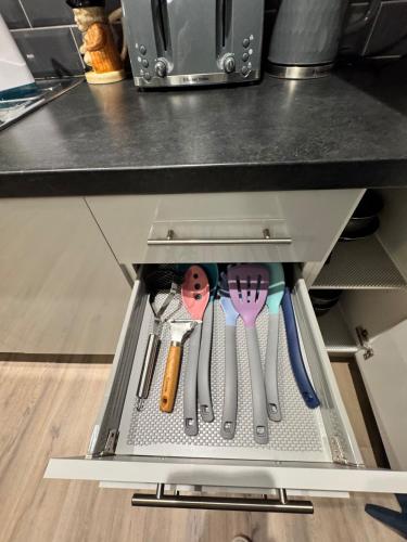 a drawer in a kitchen with utensils in it at 2 have fun in Huntingdon entire flat in Huntingdon