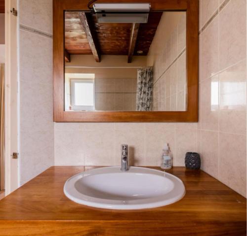 a white sink in a bathroom with a mirror at Gîte de Lafargue - maison en pierre lumineuse in Cazes-Mondenard