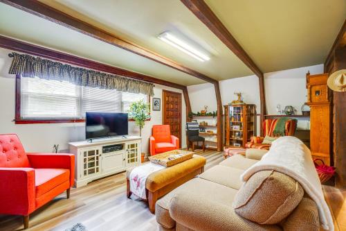 a living room with a couch and a tv at A-Frame Cabin with Spacious Yard in Tellico Plains! in Tellico Plains
