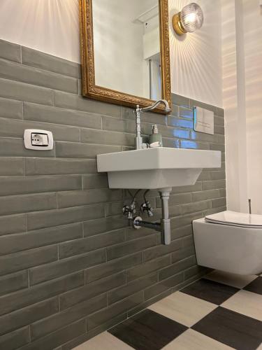 a bathroom with a sink and a toilet at Charming Beachfront Retreat in Riposto