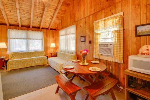 a living room with a table and a bedroom at The Birches Raymond Getaway with Beach and Boat Dock in Raymond
