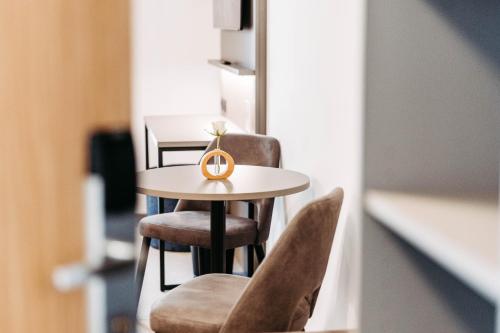 a small table and chairs with a ring on it at Easy Room - Self Check In - Out in Höchst