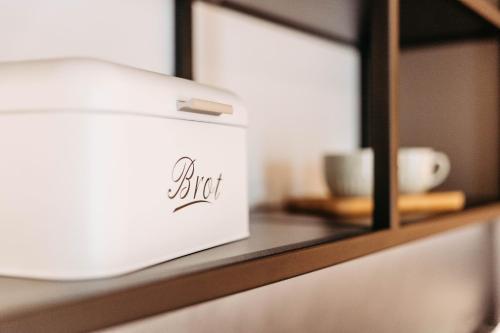 a white box sitting on a shelf with a mirror at Easy Room - Self Check In - Out in Höchst