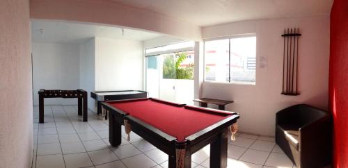 a room with a pool table and a window at Hotel Bauer in Torres