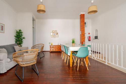 a living room with a table and chairs at Down Town Beach House in Albufeira