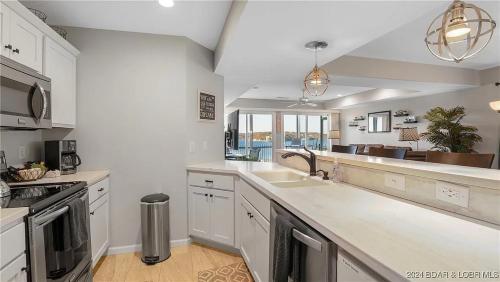 a kitchen with a sink and a counter top at Gourgeous lake views, amazing susets, on main channel in Lake Ozark