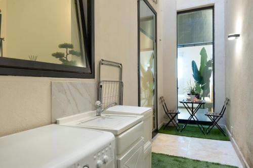 a white kitchen with a sink and a window at Seaside Apartment Near St Nicholas Basilica in Bari