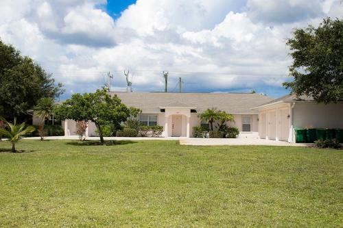 a large white house with a grass yard at CHD3583-C Rotunda Wes in Rotonda West