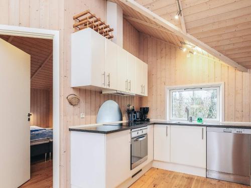 a kitchen with white cabinets and a window at 6 person holiday home in Højby-By Traum in Højby