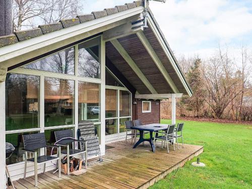 a screened in porch with a table and chairs at 6 person holiday home in Højby-By Traum in Højby