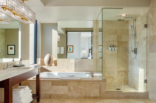 a bathroom with a tub and a shower at Hotel Ivy, a Luxury Collection Hotel, Minneapolis in Minneapolis