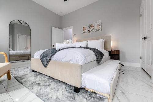 a large white bedroom with a large bed and a couch at 10 Mins from NRG 3BR 3BA in Houston