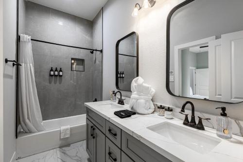 a bathroom with a sink and a shower and a tub at 10 Mins from NRG 3BR 3BA in Houston