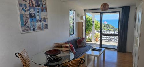 a living room with a couch and a glass table at Deluxe Seaview Chalet 6 by Palm Beach Chalets in Palm Beach