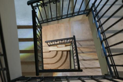 a spiral staircase in a building with a painting on the wall at Palazzo Giudecca in Reggio Calabria