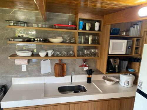 a kitchen with a sink and a counter top at Bangalô Mar & Sol in Alcobaça