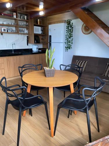 a wooden table and chairs in a kitchen at Bangalô Mar & Sol in Alcobaça