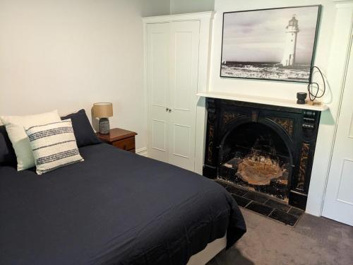 a bedroom with a bed and a fire place at Heritage Chic in Central Albury in Albury