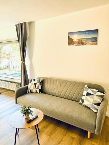 a living room with a couch and a table at Apartment 4you köln-Frechen in Frechen