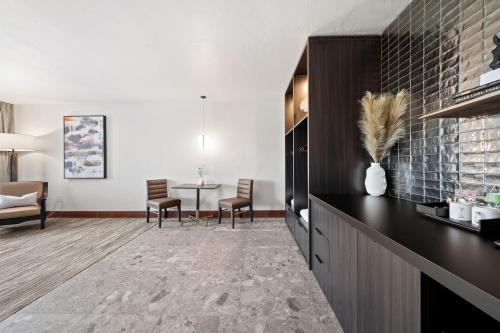 a kitchen with a black counter and a dining room at Flying Horse Resort & Club in Colorado Springs