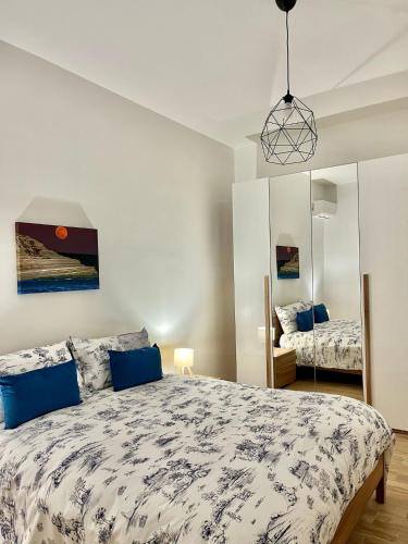 a bedroom with a large bed and a mirror at Emma's House in Agrigento