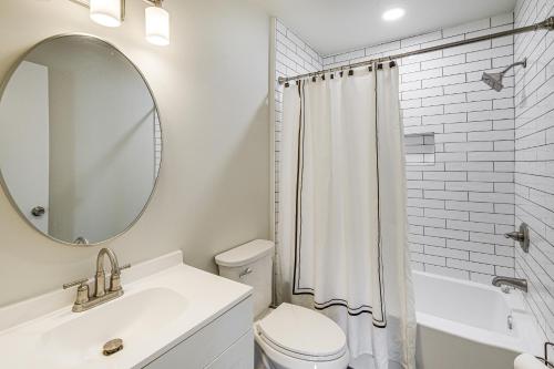 a bathroom with a toilet and a sink and a mirror at 5 Mi to Smithsonian Museum Apt in DC in Washington