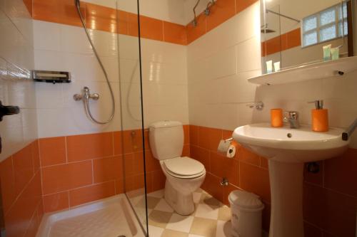 a bathroom with a toilet and a sink and a shower at Jericho rooms in Sarandë