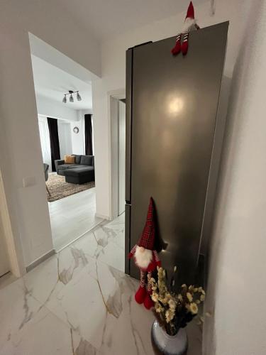 a santa claus is standing next to a refrigerator at Kyr house 2 in Piteşti