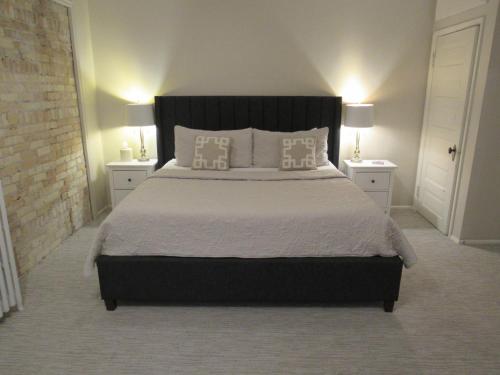 a bedroom with a large bed with two night stands at The Riter Mansion in Logan