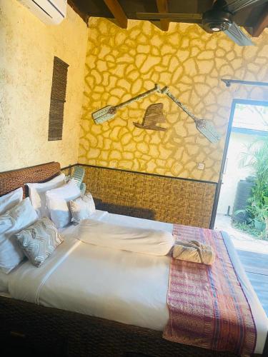 a large bed in a room with at Villa Umbrella Lombok in Senggigi 