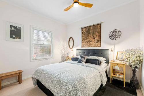 a bedroom with a bed and a ceiling fan at Osprey 9 in Queenscliff