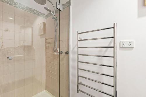 a shower in a bathroom with a glass door at Osprey 9 in Queenscliff
