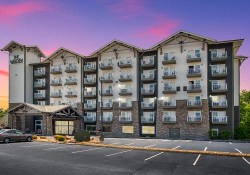 a large apartment building with a parking lot at The Walden, Trademark Collection By Wyndham in Pigeon Forge