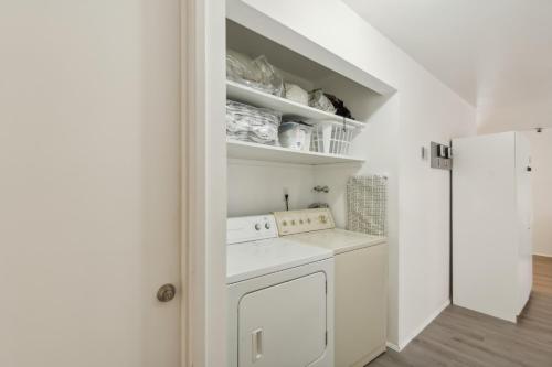 a white laundry room with a washer and dryer at Central Bellevue Retreat in Bellevue