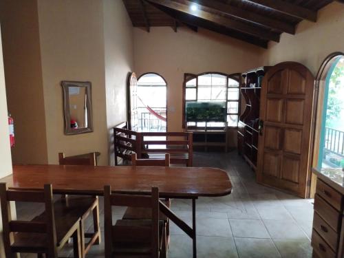 a dining room with a wooden table and chairs at Osa House - Drake Corcovado Tours in Drake