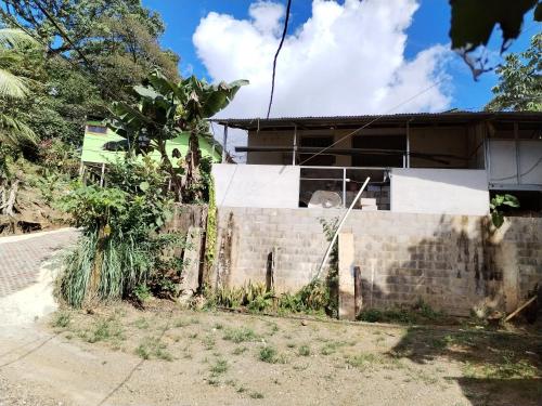 a house with a fence in front of it at Osa House - Drake Corcovado Tours in Drake