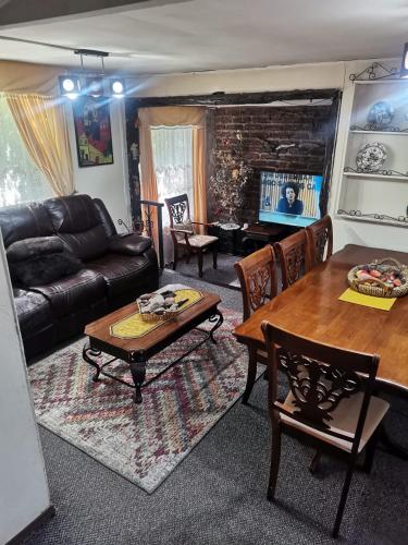 a living room with a couch and a table at Casa Villarrica, El Alba 2128 in Villarrica