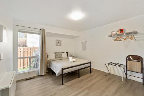 a bedroom with a bed and a table and a window at Central Bellevue Retreat in Bellevue