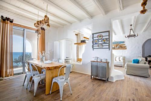 a dining room with a table and chairs at Axiotheaton Villas in Pefki Rhodes