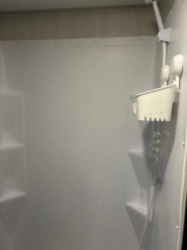 a bathroom with a phone hanging on the wall at Sleepyheadz Campers and Tents LLC in Bloomington