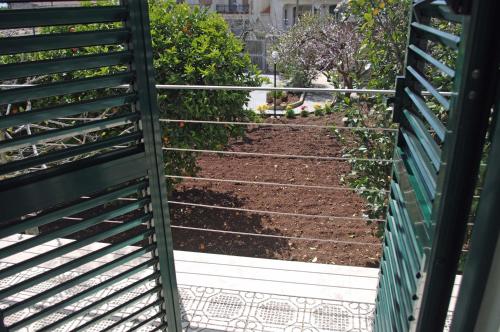 a garden with a fence and some plants at La Piccola Locanda in Modica