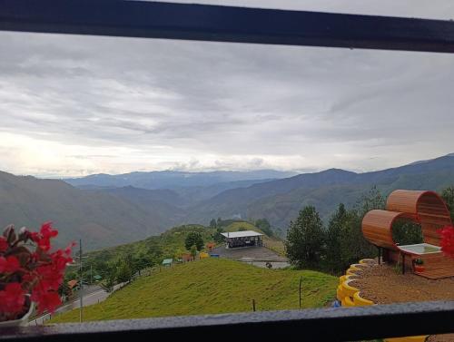 a view of a mountain with a building on a hill at Glamping Arcoiris in Ciudad Bolívar