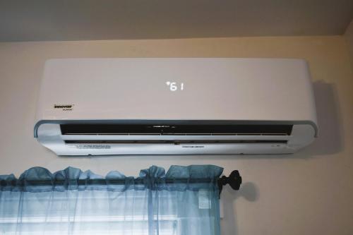 a air conditioner is hanging on a wall at Downtown Lima 1 Bdrm Haven! in Lima
