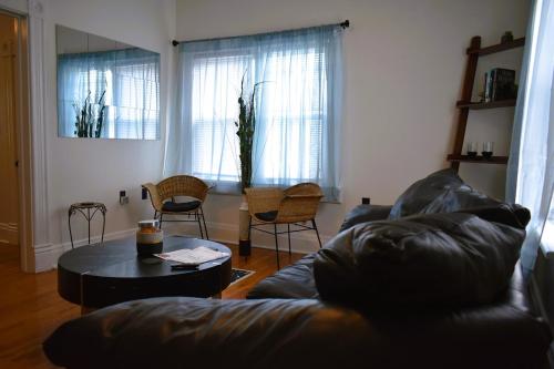 a living room with a couch and a table at Downtown Lima 1 Bdrm Haven! in Lima